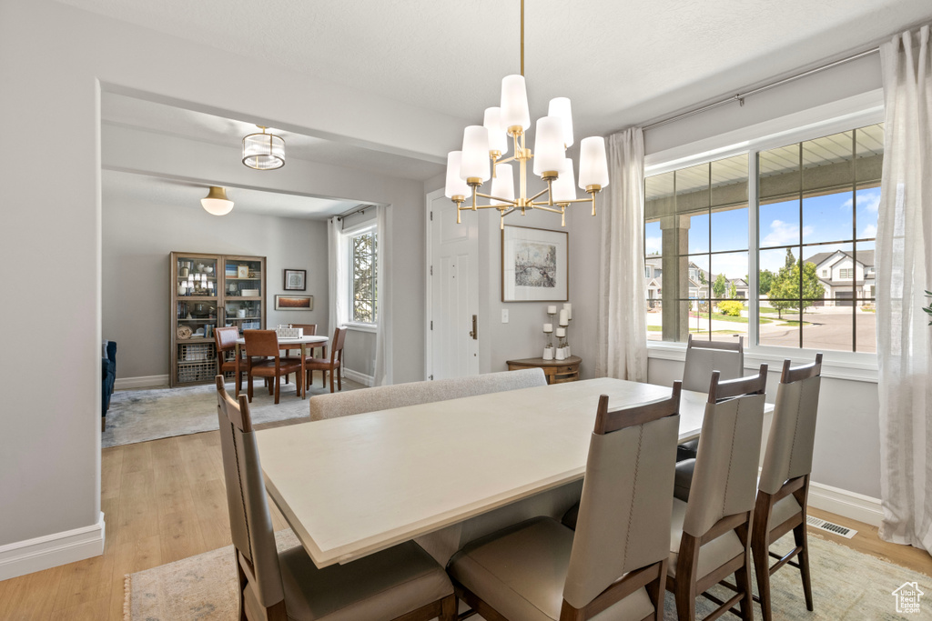 Dining room with a chandelier and light hardwood / wood-style floors