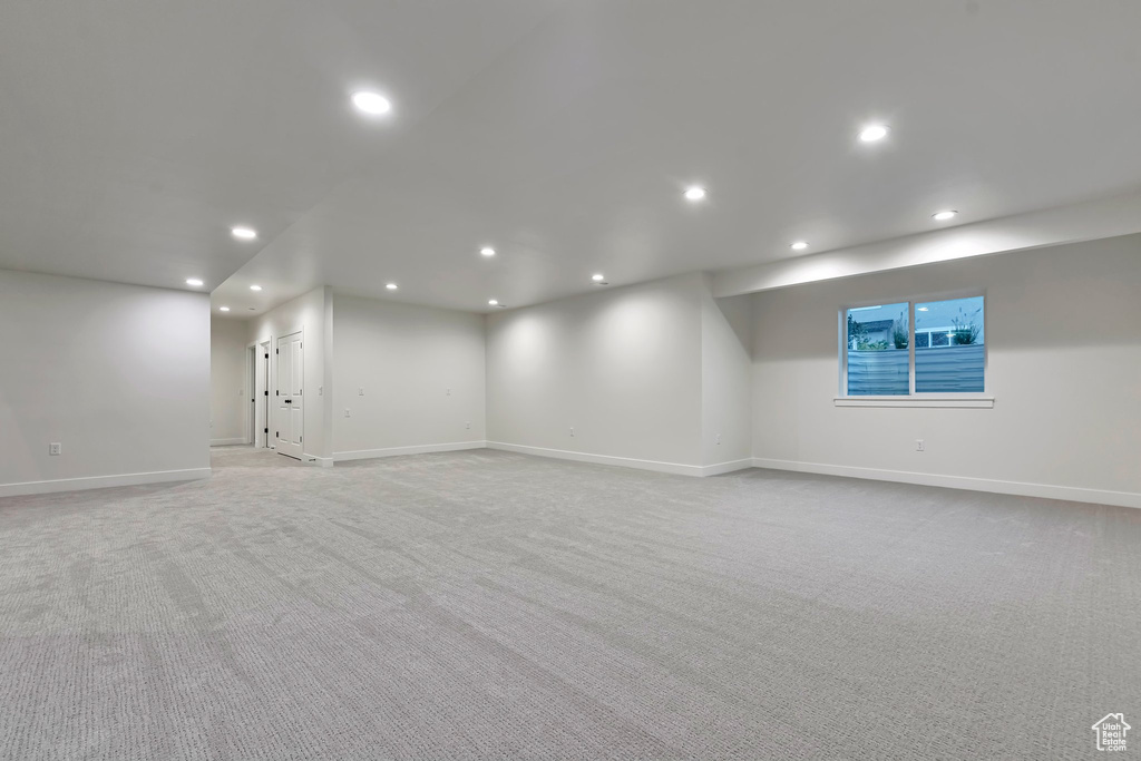 Basement featuring light colored carpet