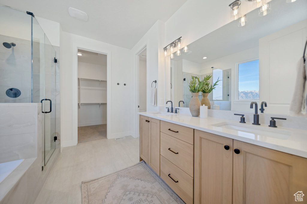 Bathroom featuring walk in shower and vanity