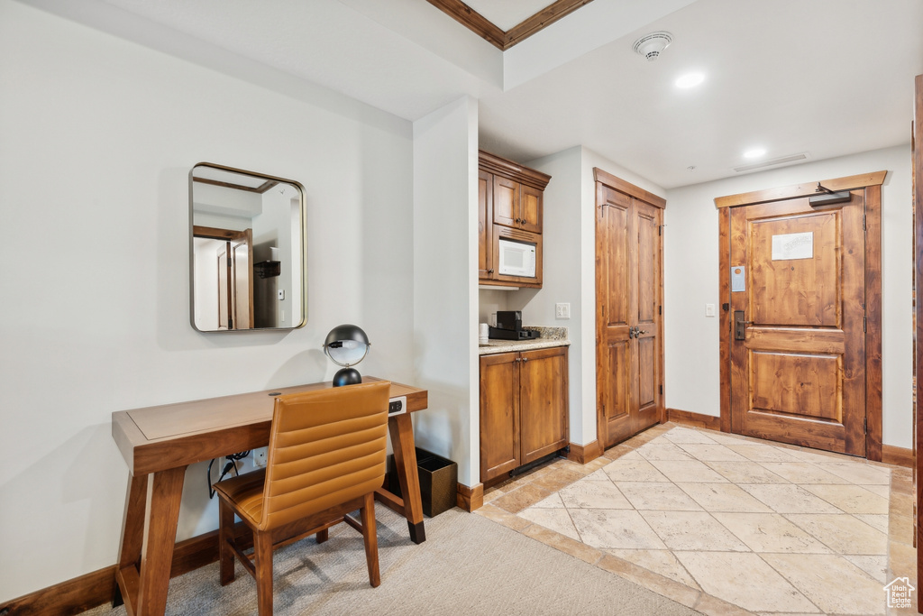 Kitchen featuring light colored carpet and white microwave