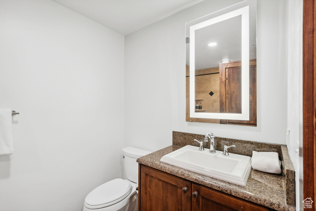 Bathroom featuring vanity and toilet