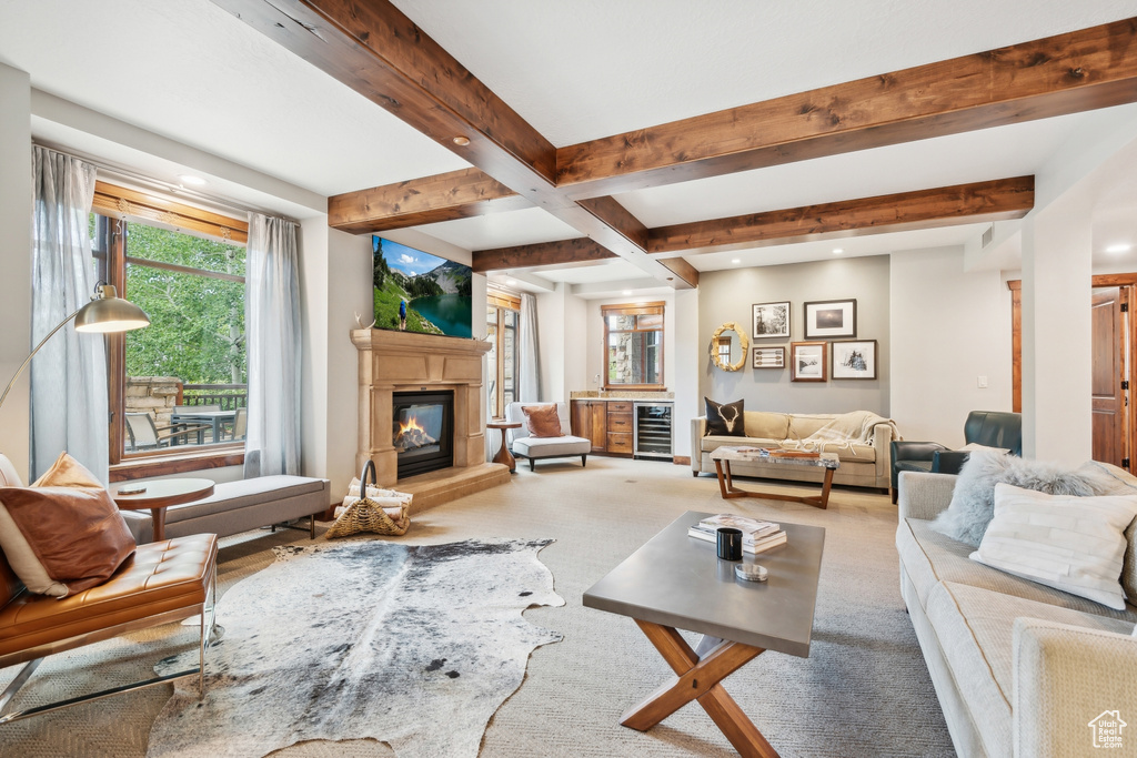 Carpeted living room featuring beamed ceiling and wine cooler