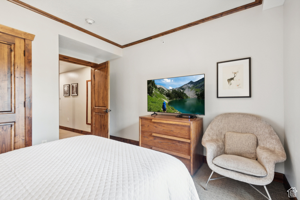 Carpeted bedroom featuring ornamental molding