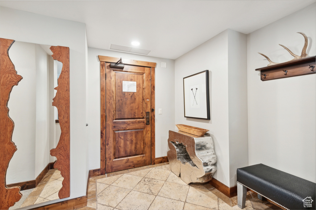 Foyer entrance featuring light tile patterned floors