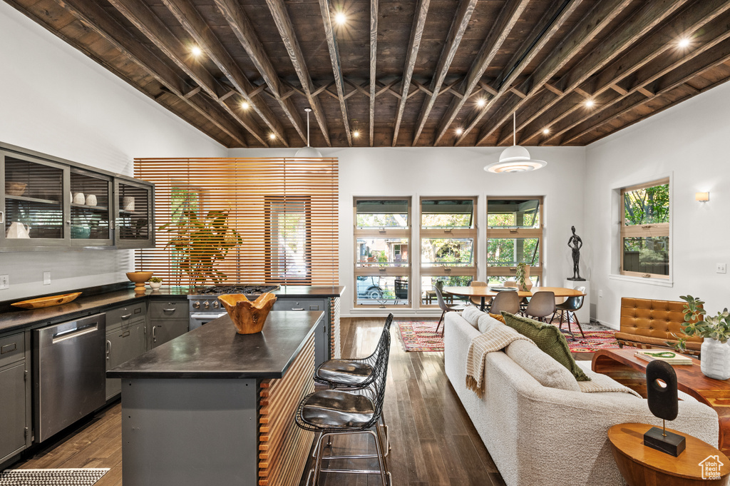 Kitchen with a kitchen island, dark hardwood / wood-style flooring, dishwasher, hanging light fixtures, and gray cabinets