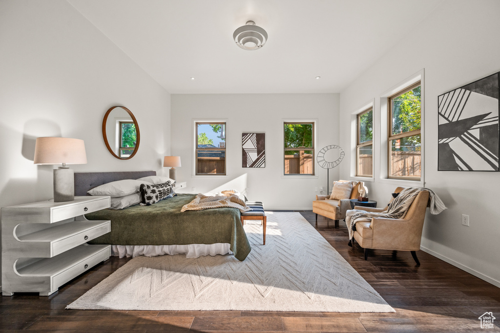 Bedroom with dark hardwood / wood-style floors