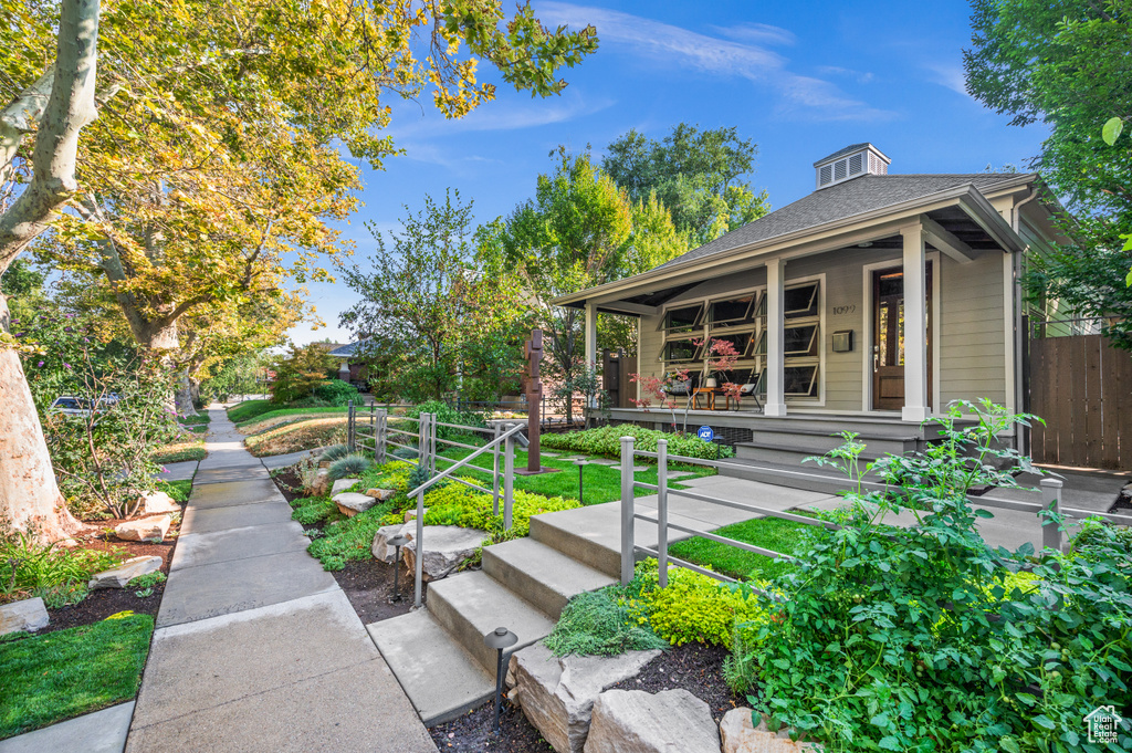 Exterior space with a yard and covered porch