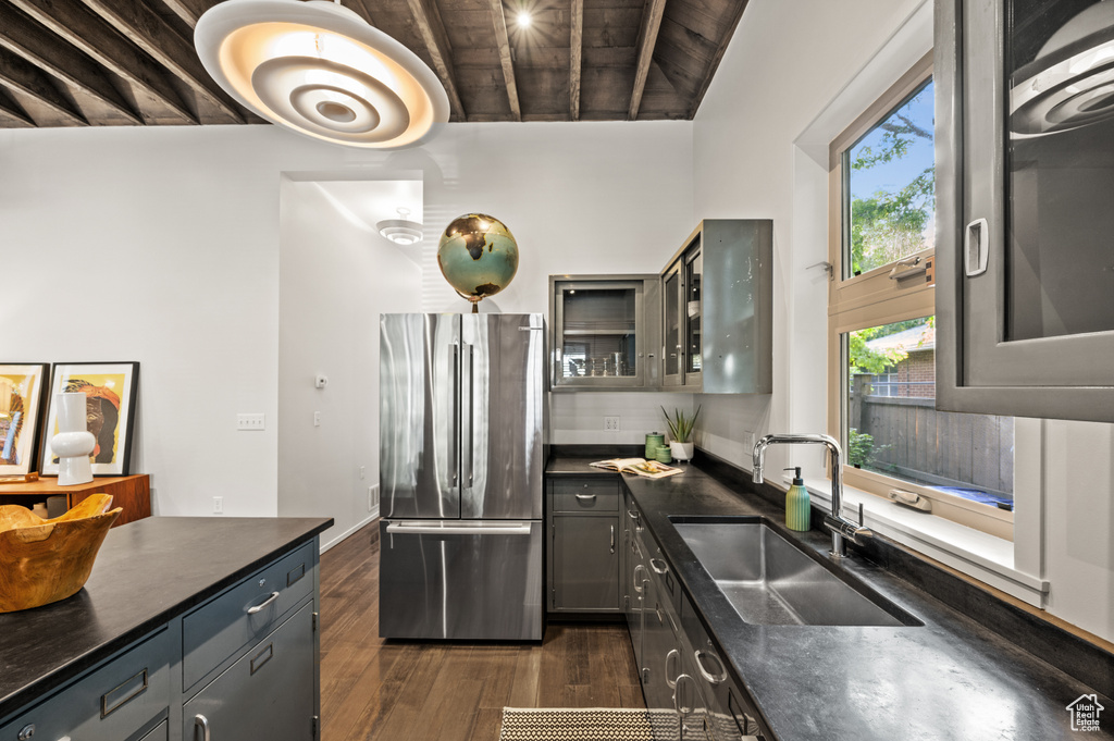 Kitchen with stainless steel fridge, dark hardwood / wood-style flooring, sink, wood ceiling, and gray cabinetry