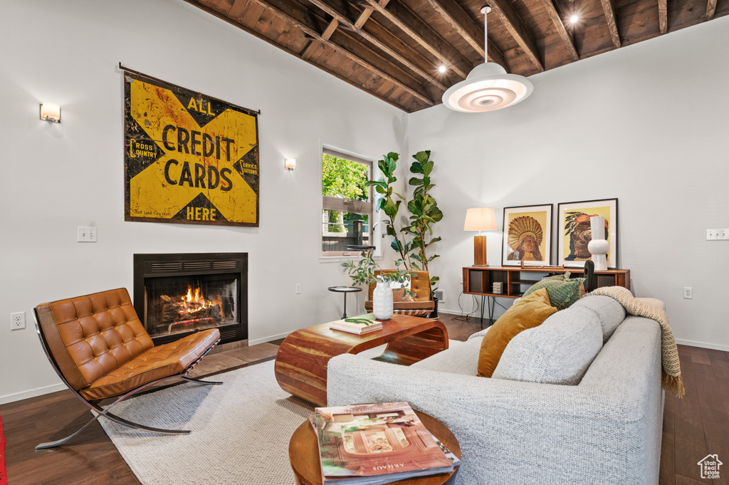 Living room featuring hardwood / wood-style flooring, beam ceiling, and wooden ceiling