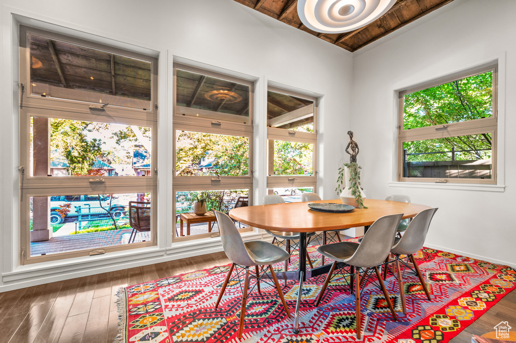 Dining room featuring wood ceiling, plenty of natural light, and dark hardwood / wood-style floors