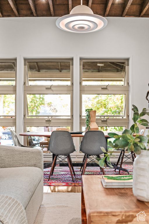 Living room featuring wooden ceiling, wood-type flooring, and vaulted ceiling with beams