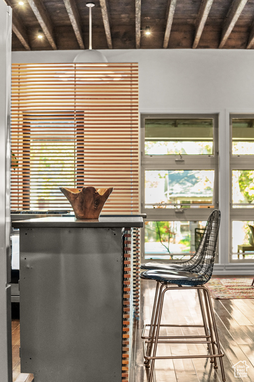 Interior space with plenty of natural light, hardwood / wood-style floors, and beam ceiling