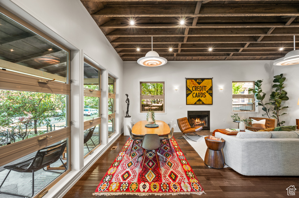 Living room with dark wood-type flooring and beam ceiling