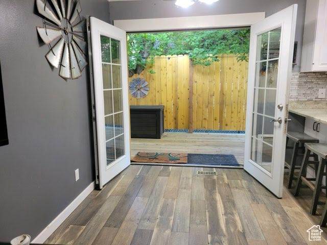 Entryway with french doors and wood-type flooring