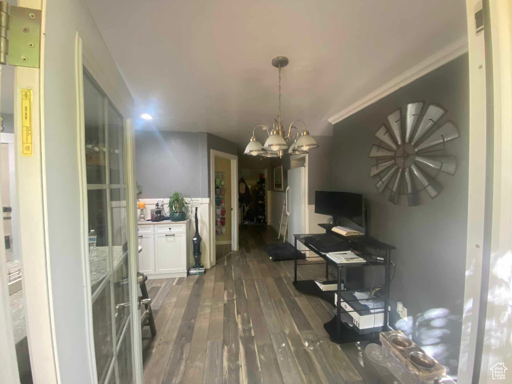 Dining room with a chandelier and dark hardwood / wood-style flooring