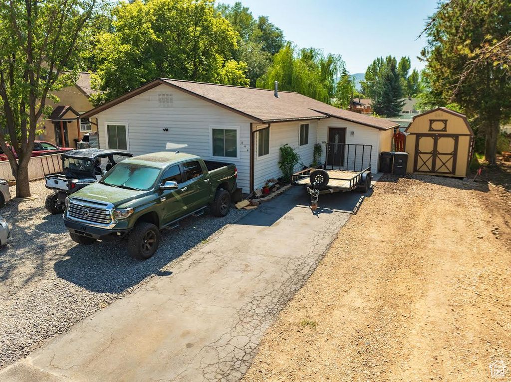 Single story home featuring a shed