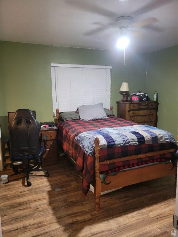 Bedroom featuring hardwood / wood-style floors and ceiling fan