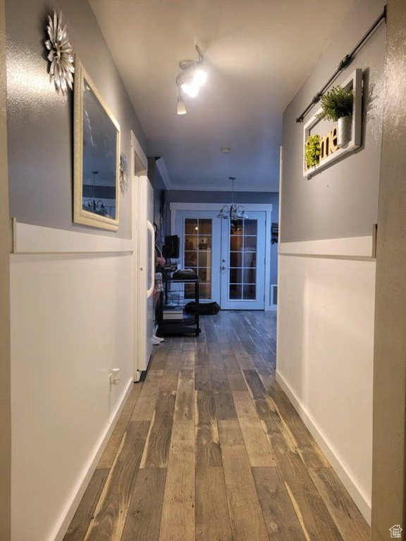 Hall with french doors and dark hardwood / wood-style floors