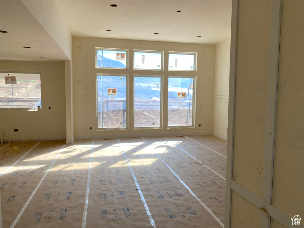 Unfurnished room with a healthy amount of sunlight