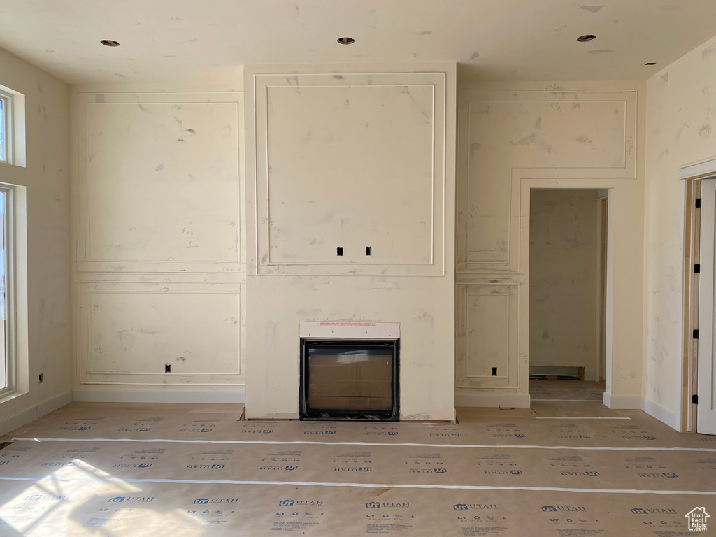 Unfurnished living room featuring heating unit