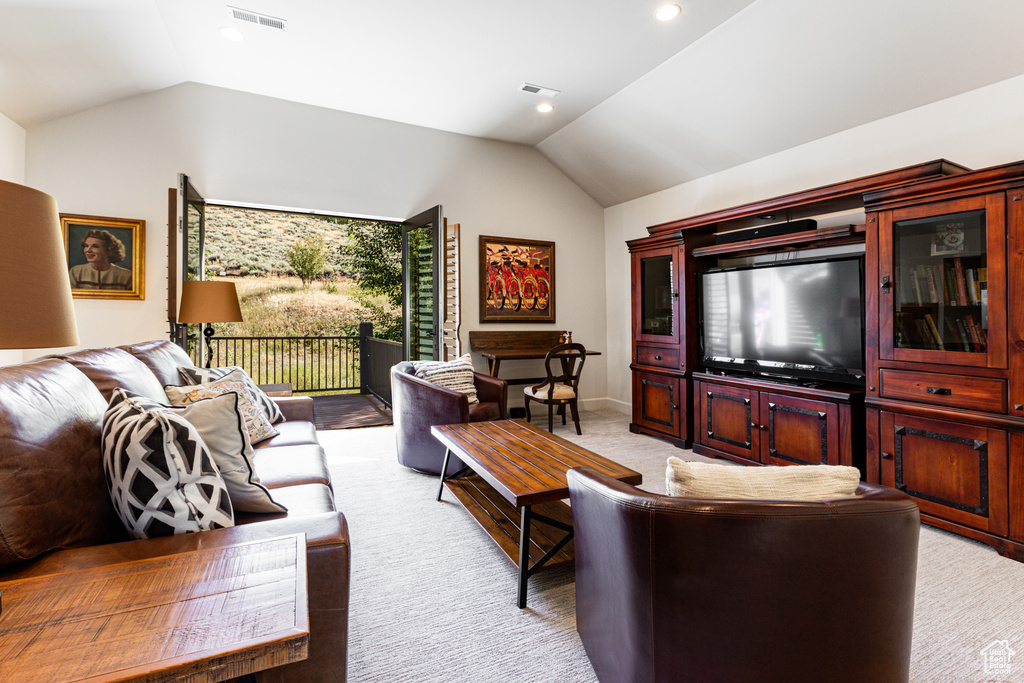 Living room with vaulted ceiling and carpet flooring