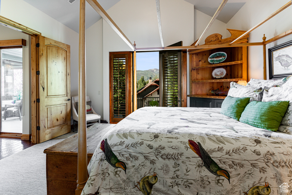 Bedroom featuring hardwood / wood-style flooring and access to exterior