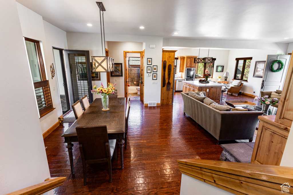 Dining room with dark hardwood / wood-style floors