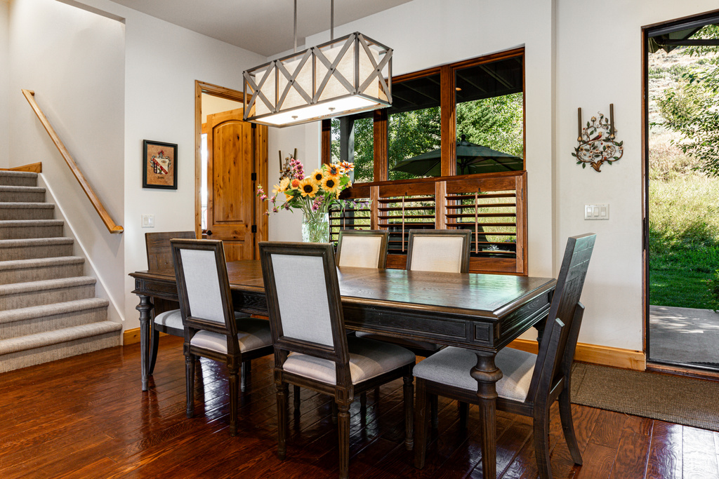 Dining room with dark hardwood / wood-style floors