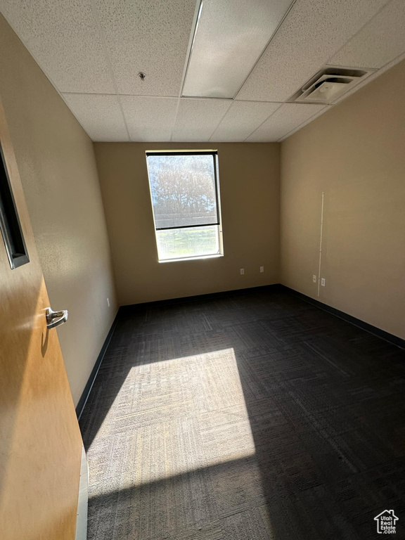 Carpeted spare room with a drop ceiling