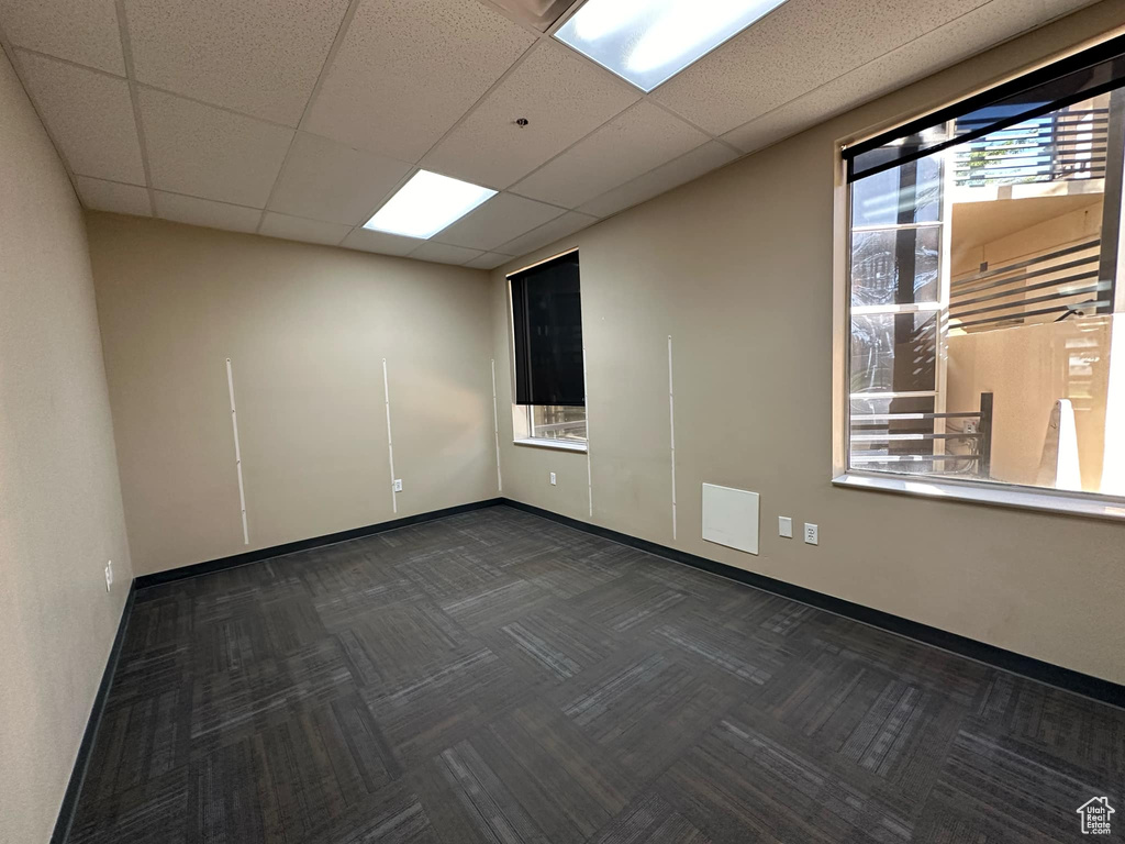 Unfurnished room with a drop ceiling