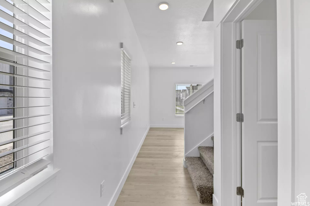 Corridor with light hardwood / wood-style flooring