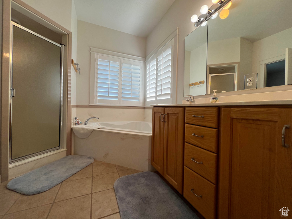 Bathroom featuring vanity, independent shower and bath, and tile patterned flooring