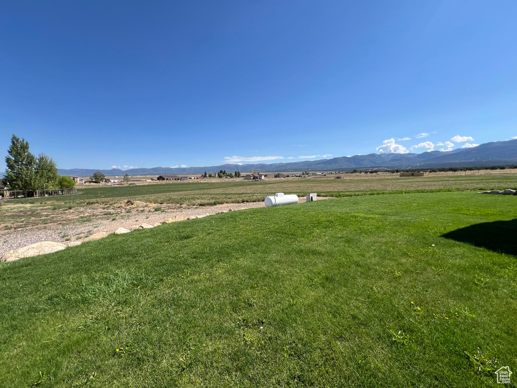 View of yard with a mountain view and a rural view