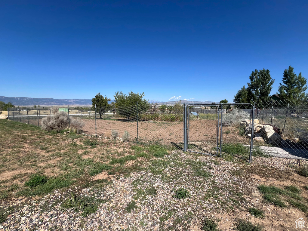 View of yard featuring a rural view and a mountain view