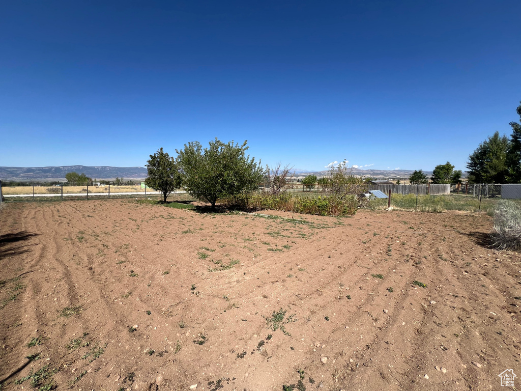 View of yard with a rural view