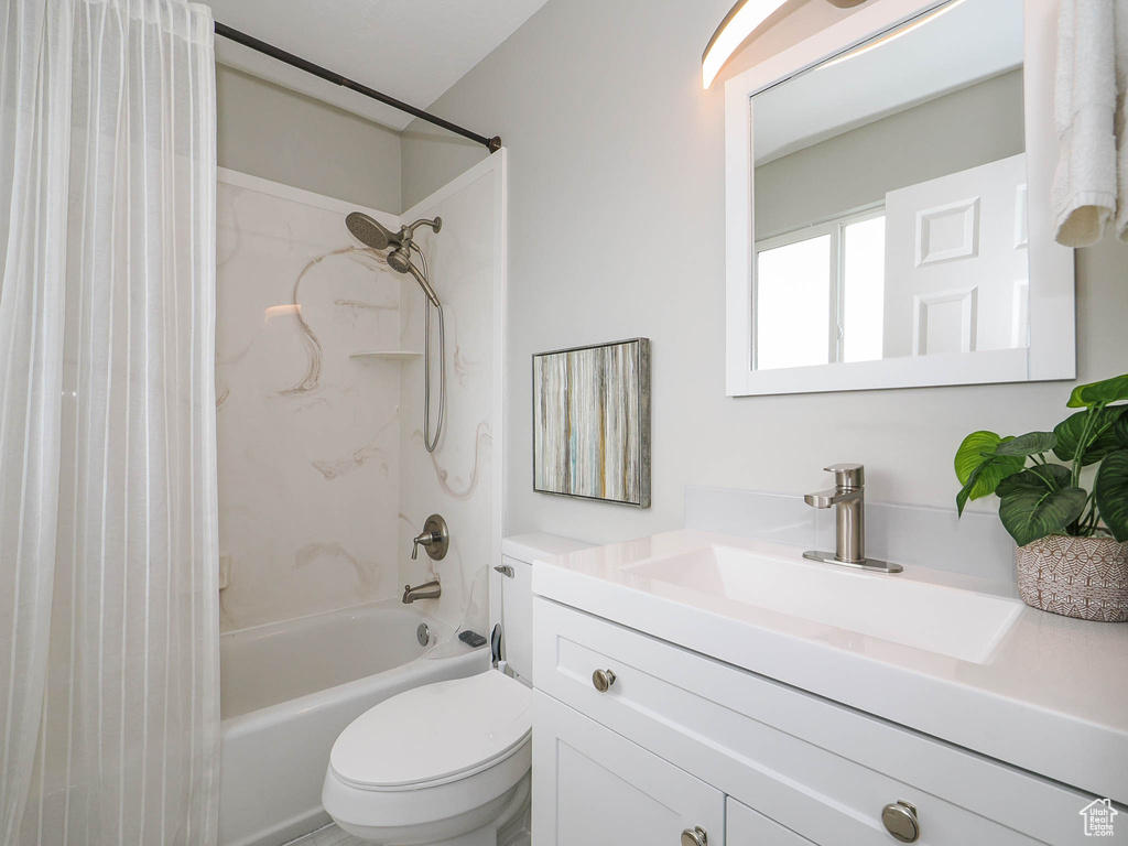 Full bathroom featuring shower / bath combo, toilet, and vanity