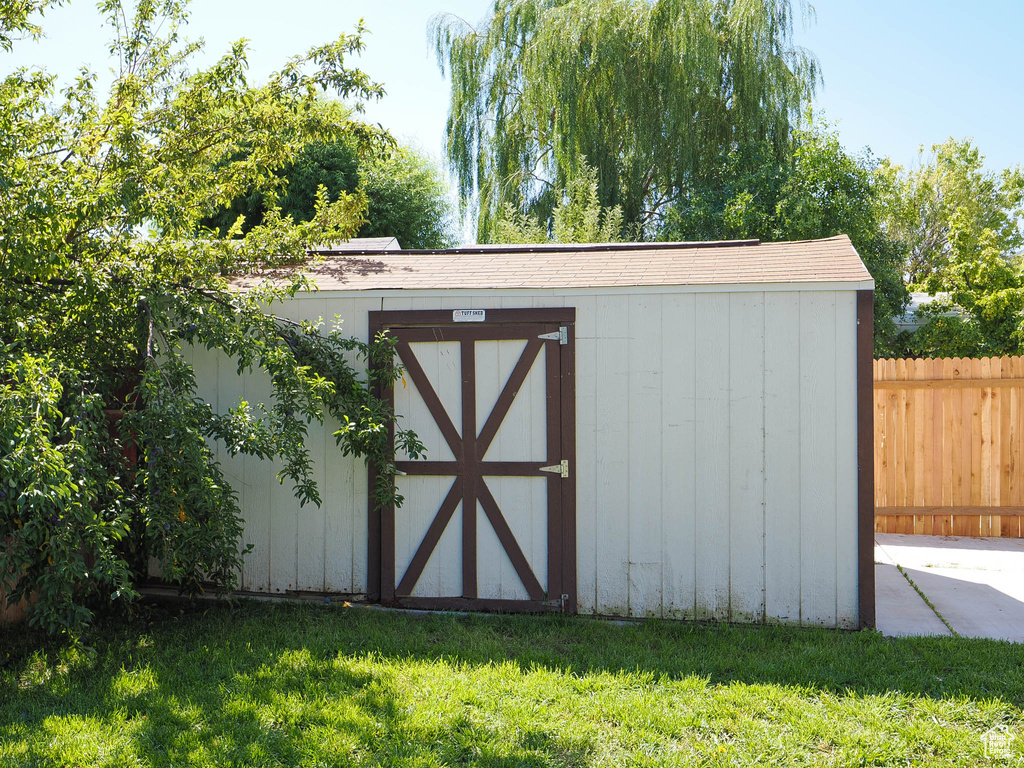 View of outdoor structure with a lawn