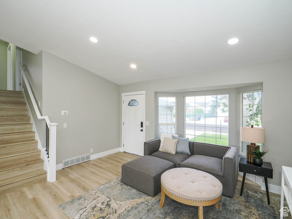 Living room with light hardwood / wood-style floors