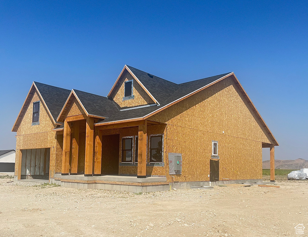 Property under construction with covered porch