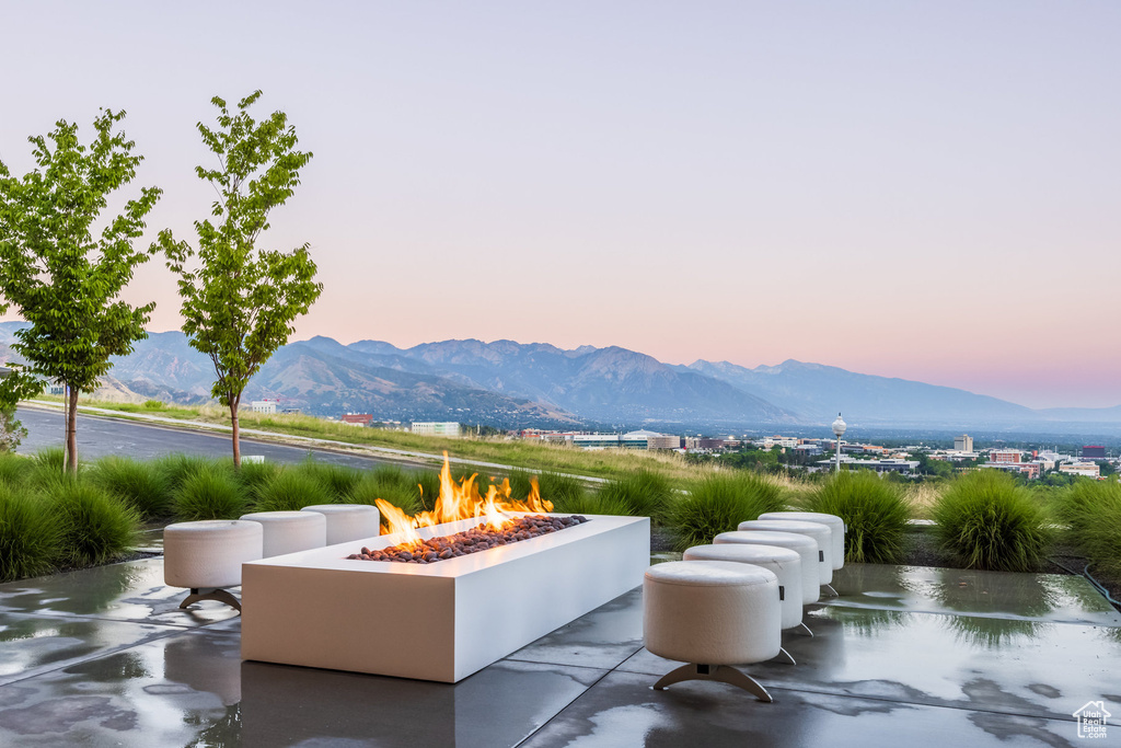 Patio terrace at dusk featuring a mountain view and an outdoor fire pit