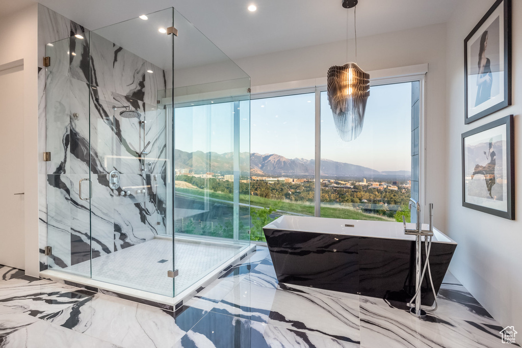 Bedroom with a mountain view and multiple windows