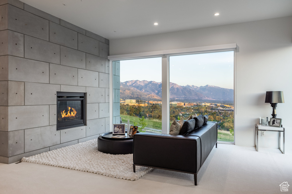 Living room featuring a fireplace, a mountain view, and carpet flooring