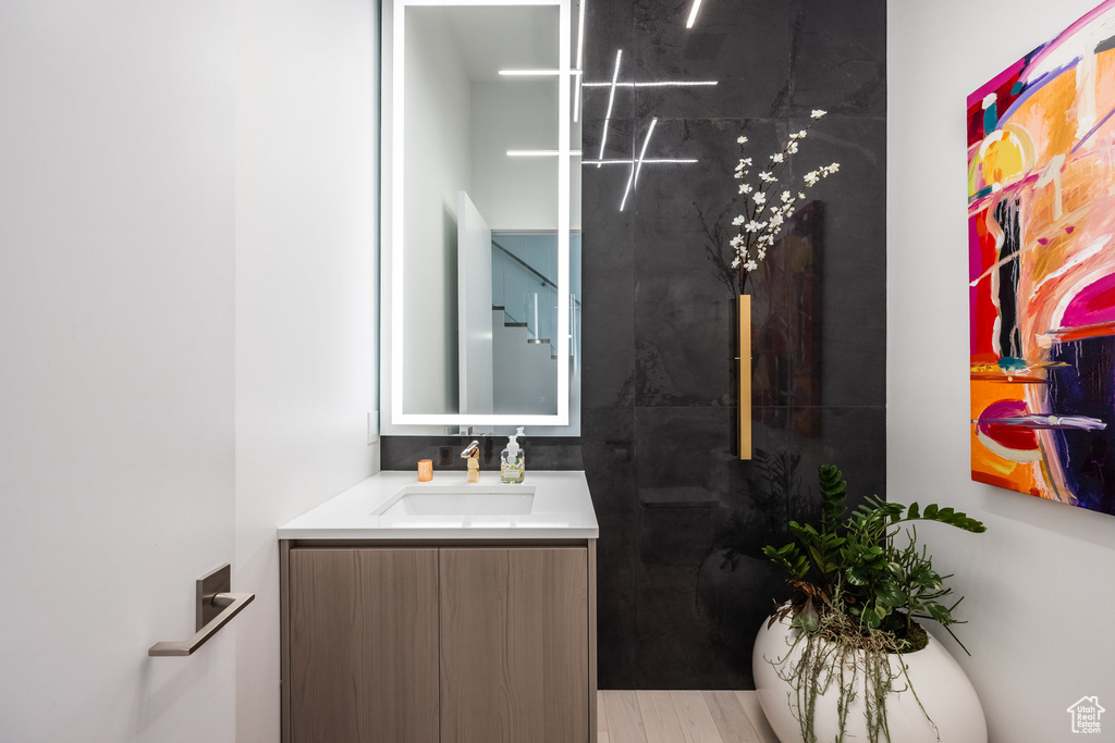 Bathroom with vanity and hardwood / wood-style flooring