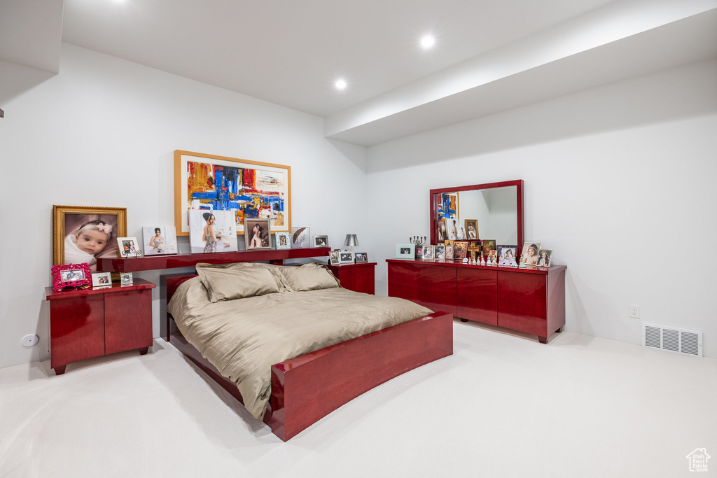 Carpeted bedroom featuring bar