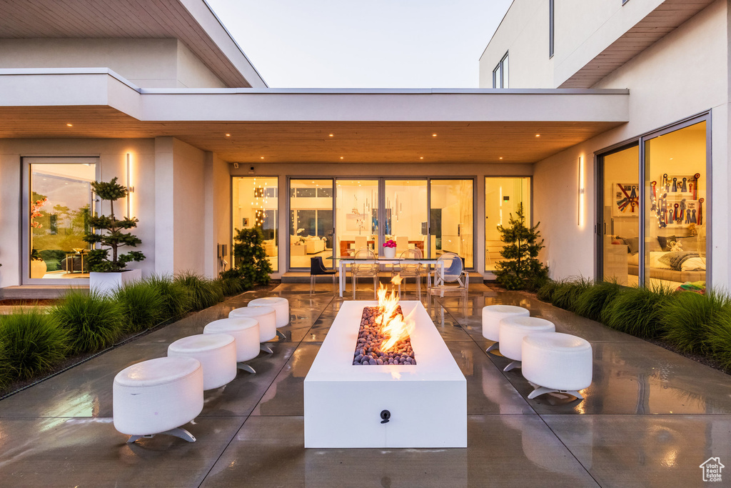 View of patio with an outdoor fire pit