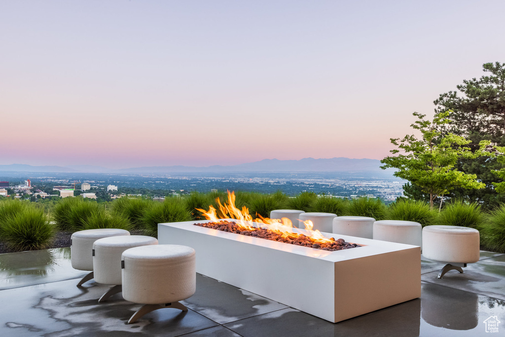 Patio terrace at dusk with a mountain view and an outdoor fire pit