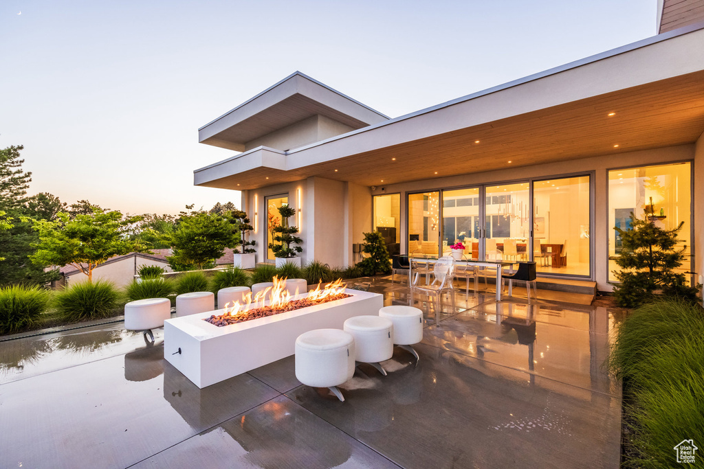 Patio terrace at dusk with a fire pit