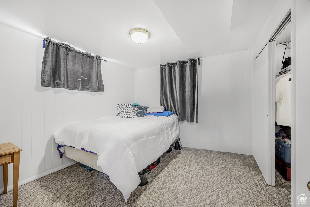 Bedroom featuring light colored carpet and a closet