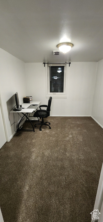 Office space featuring dark colored carpet