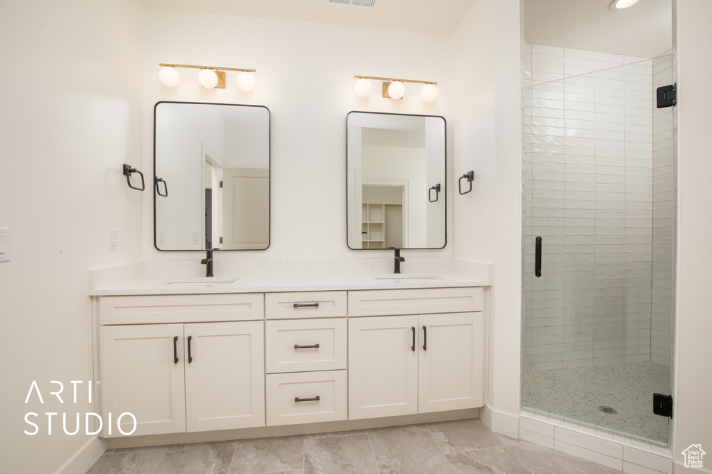 Bathroom with a shower with shower door and vanity